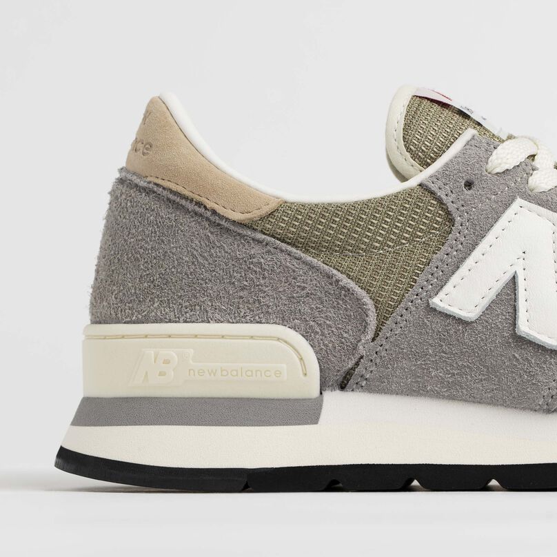 Side detail of the grey 990v1 heel and materials.